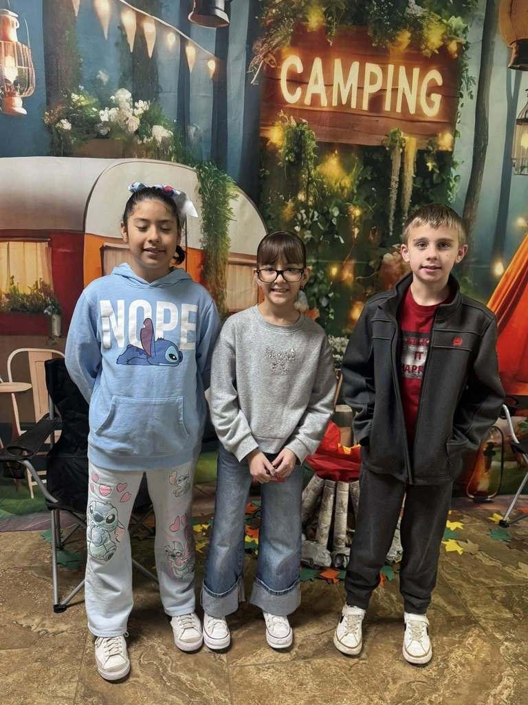 three happy campers of the week standing in front of camping background