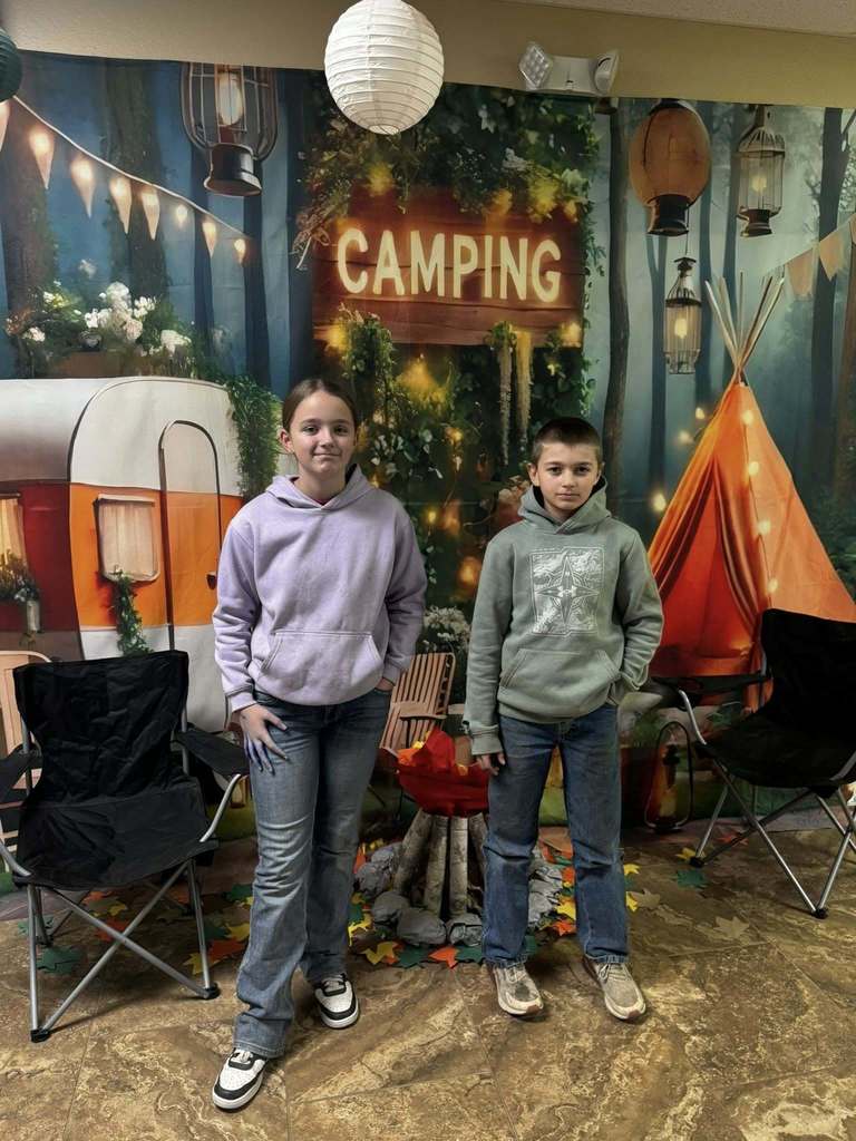 two happy campers of the week standing in front of camping background