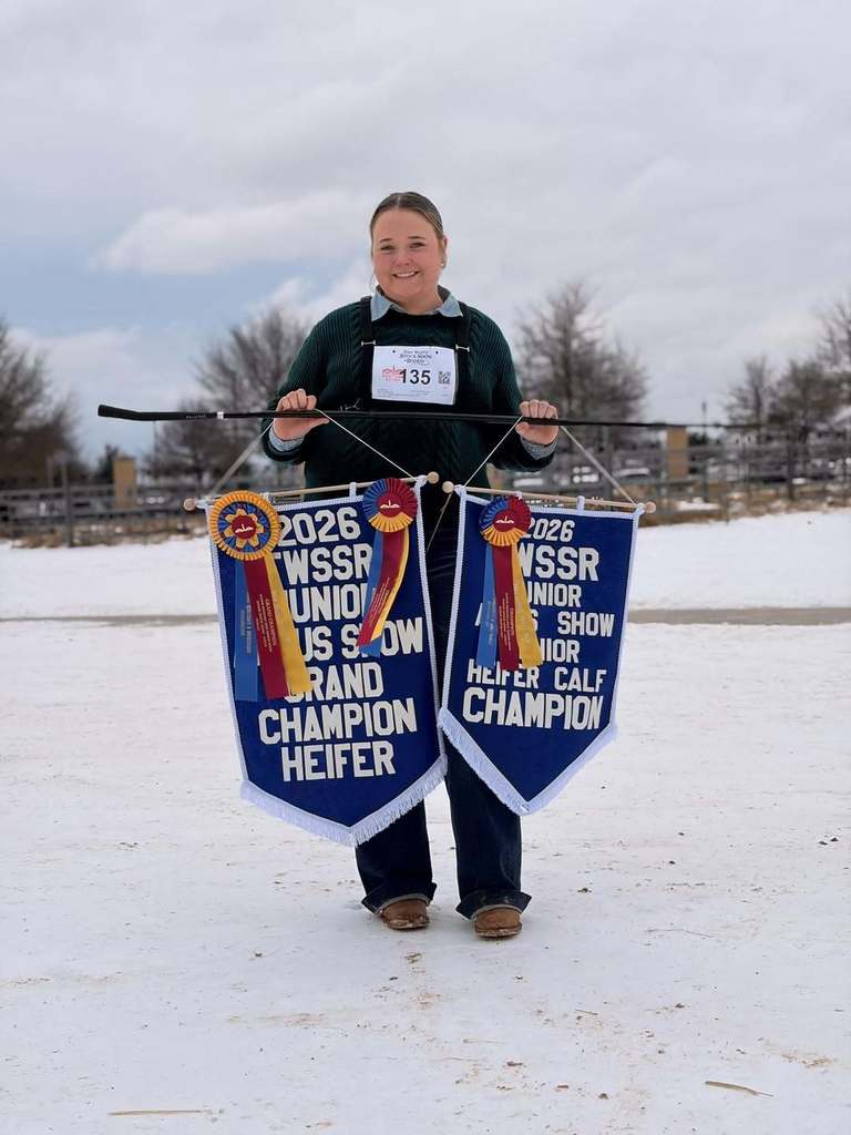 brook barnes holding her winning stock show banners