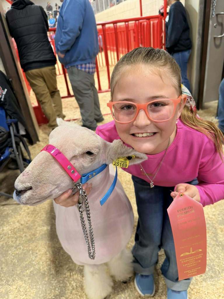 ffa member with her winning stockshow animal