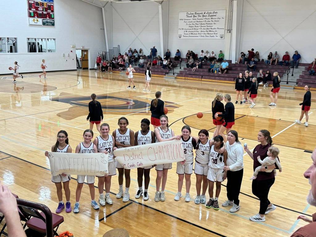 7th grade girls basketball team group photo after winning championship game