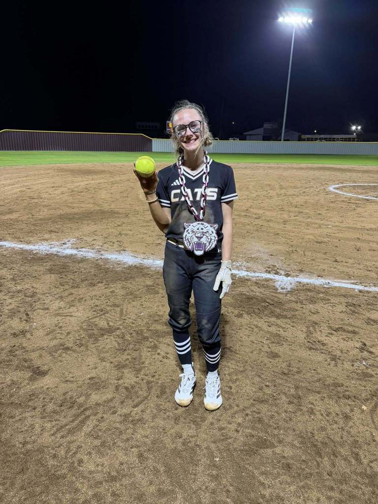 senior softball player holding in the park home run softball