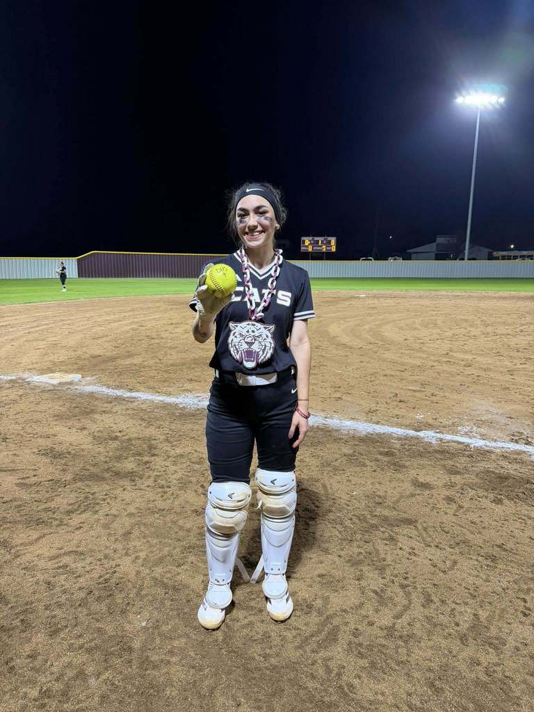 senior softball player holding in the park home run softball