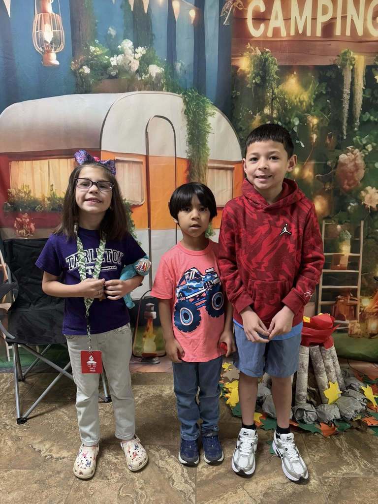 three happy campers of the week standing in front of camping backdrop