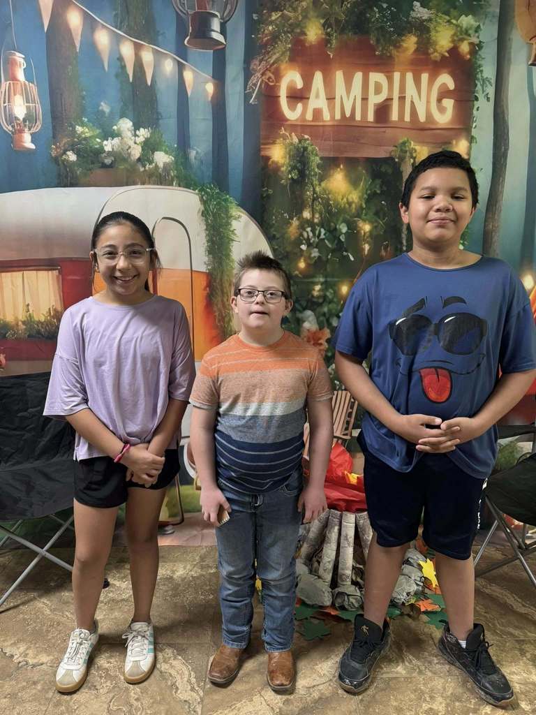three happy campers of the week standing in front of camping backdrop