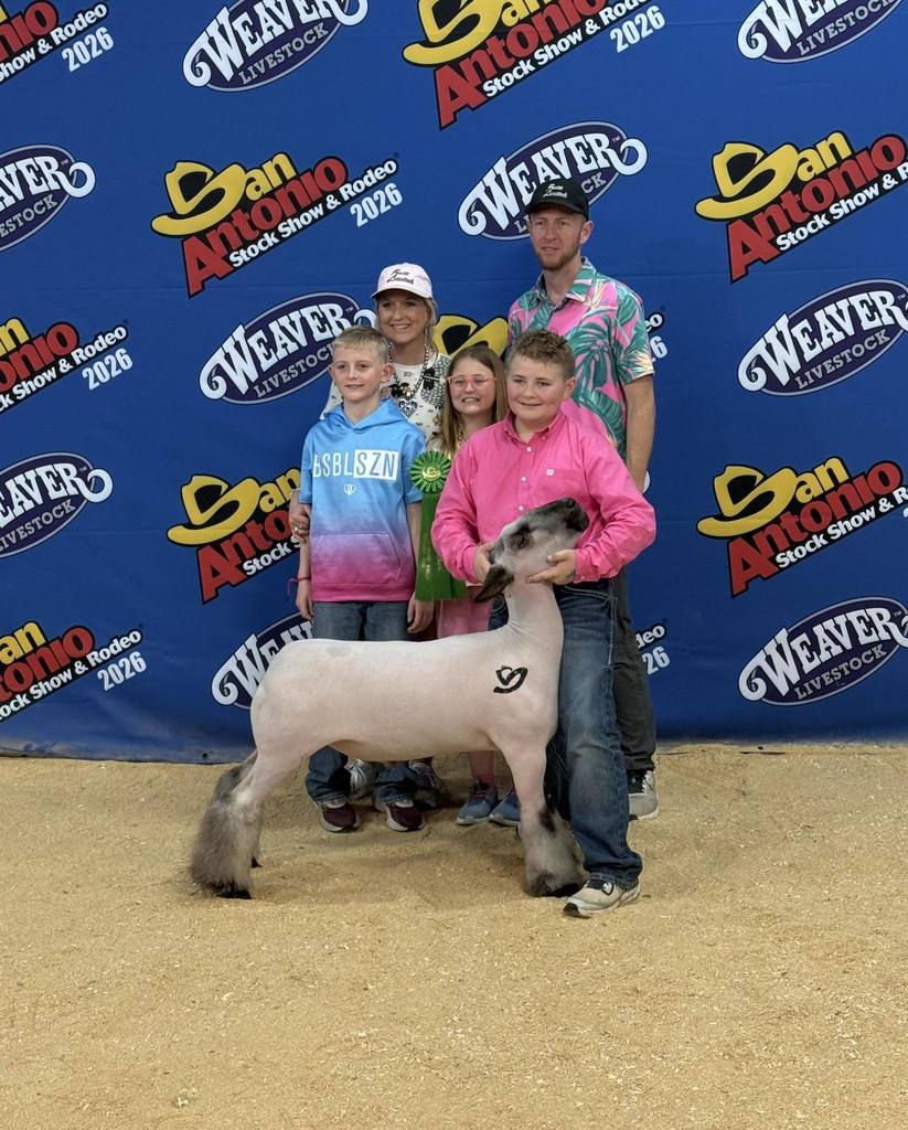 ffa member with his show animal and his family at san antonio stock show rodeo