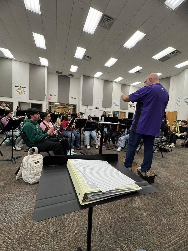 conductor directing band members in band hall practice