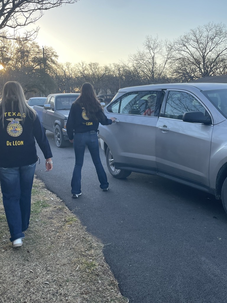 two ffa members opening car doors in elementary drop off line