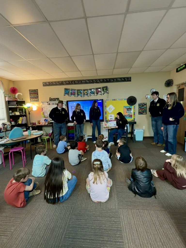 ffa students giving presentation to younger students in elementary classroom