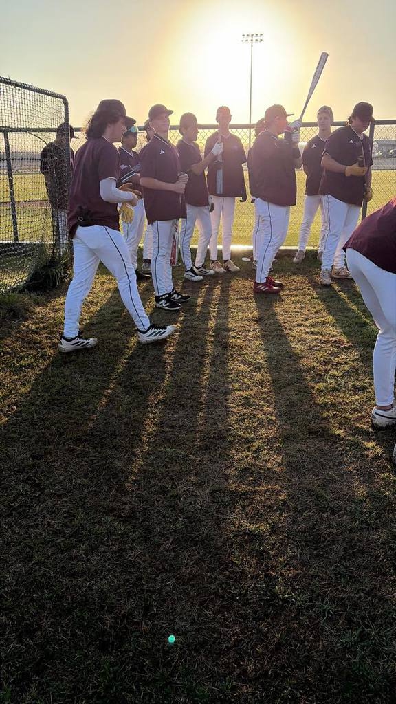 baseball players getting ready for their early morning game