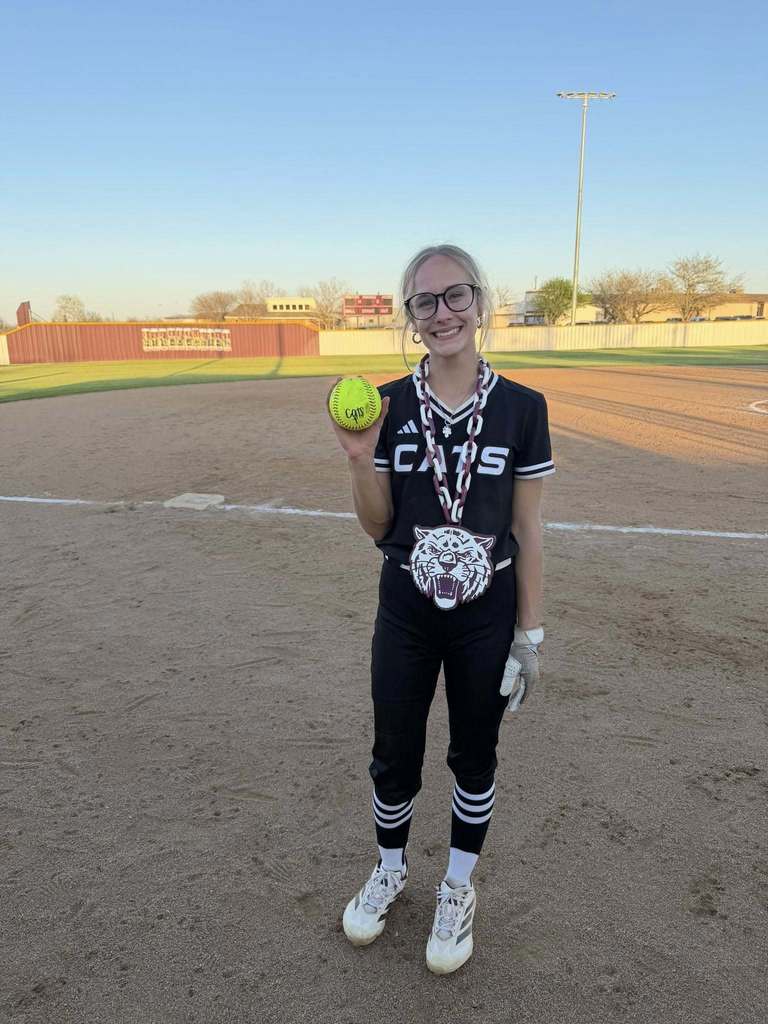 softball player holding homerun ball