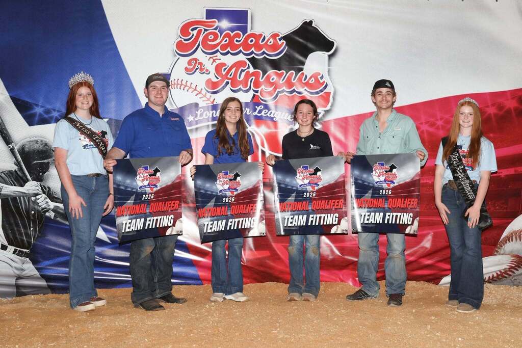 four FFA members holding national qualifier team fitting banners and two stockshow representatives