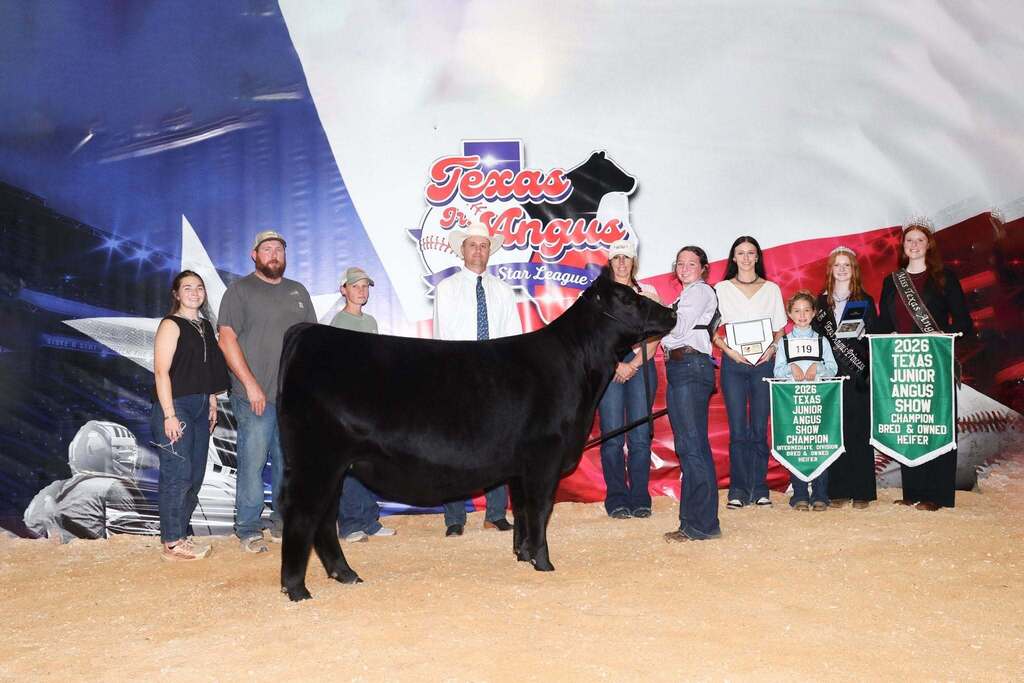 FFA member standing with angus, family and stockshow representatives