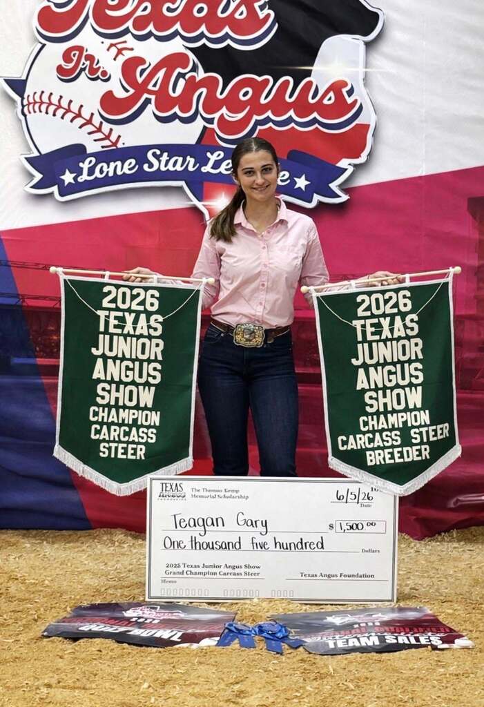FFA member at stockshow holding 2 winning banners and check