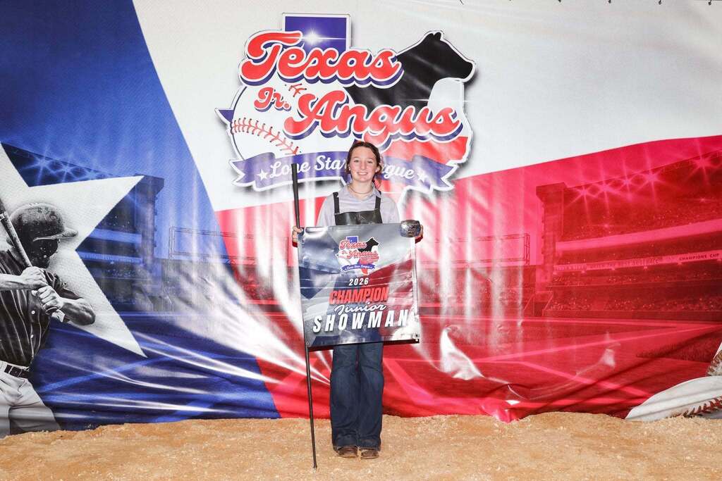 ffa member holding champion junior showman banner