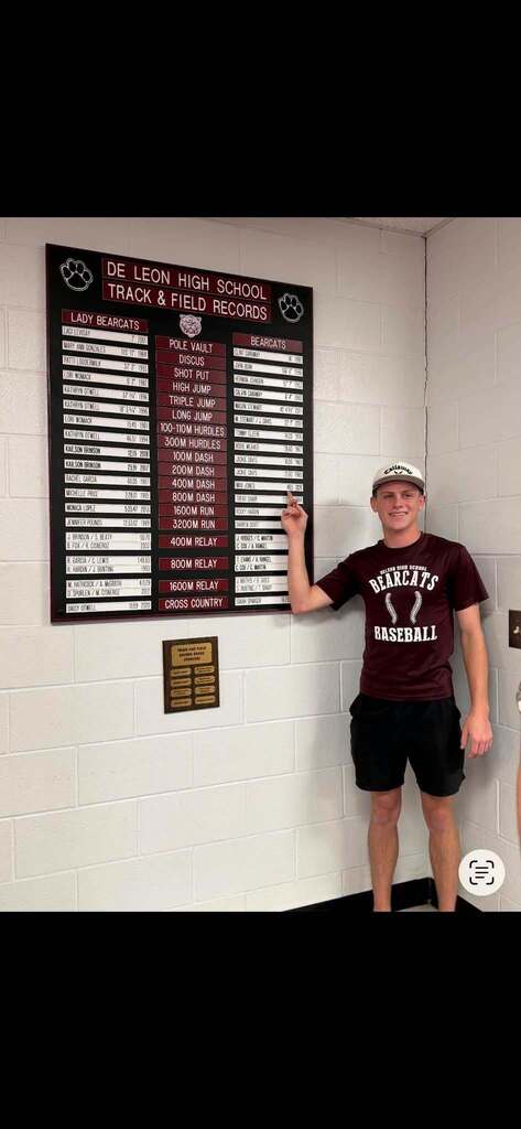 track record breaker in the 400 m, Max Jones standing next to record board