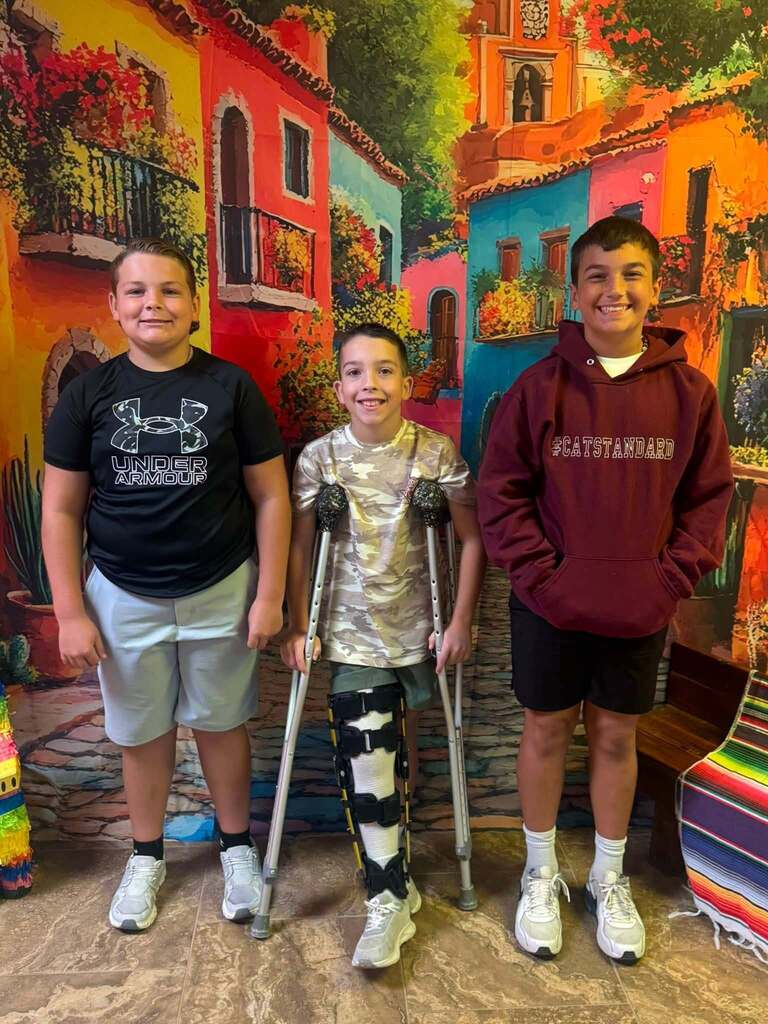 three star students of the week standing in front of decorative backdrop