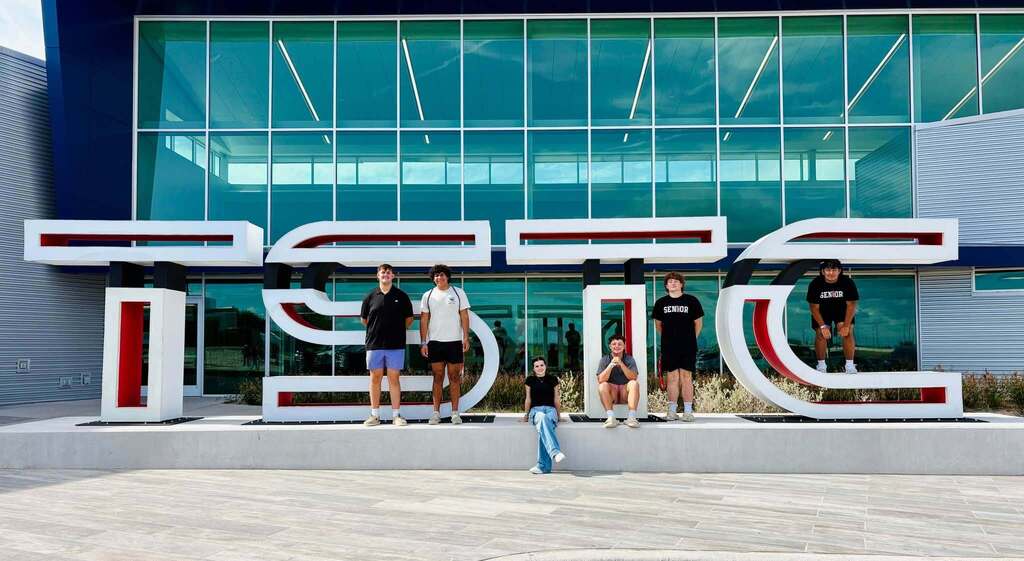 group of students posing with giant tstc letters