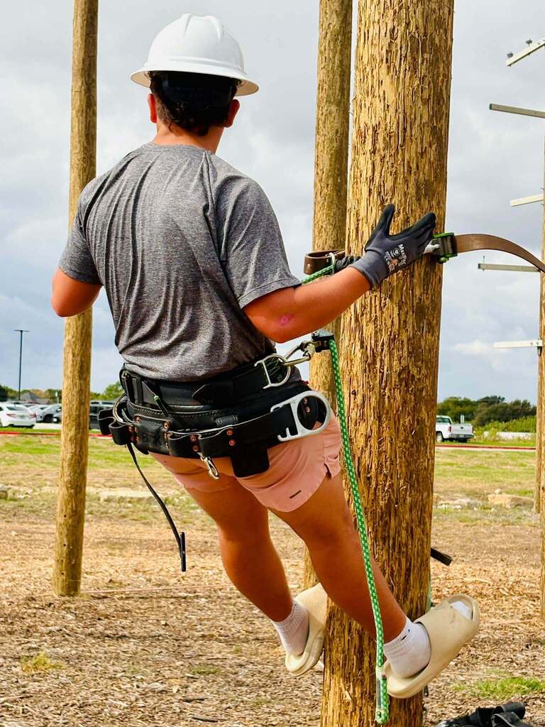 student climbing pole
