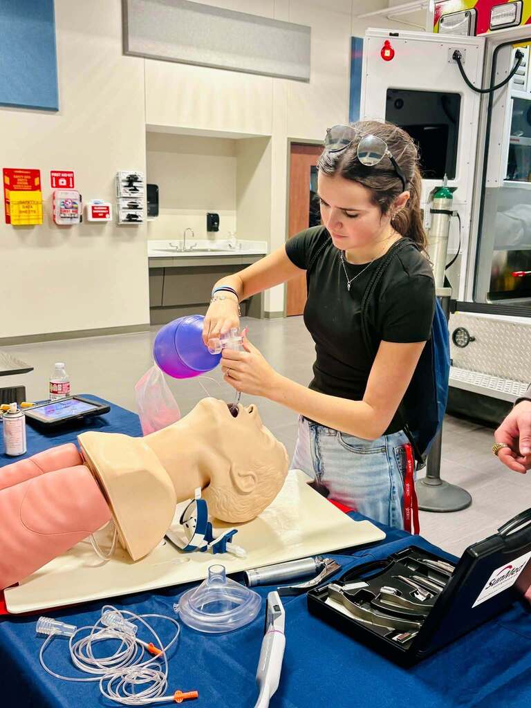 student practicing medical training on dummy