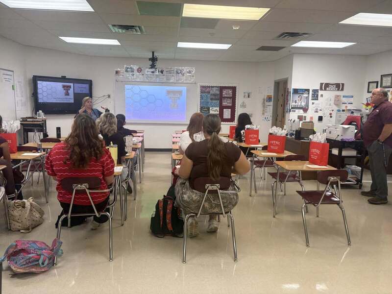 back of the class angle of students listening to guest speaker