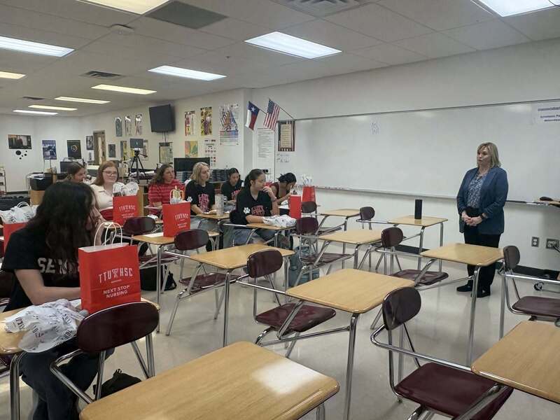 classroom with students with their gift bags and speaker looking on