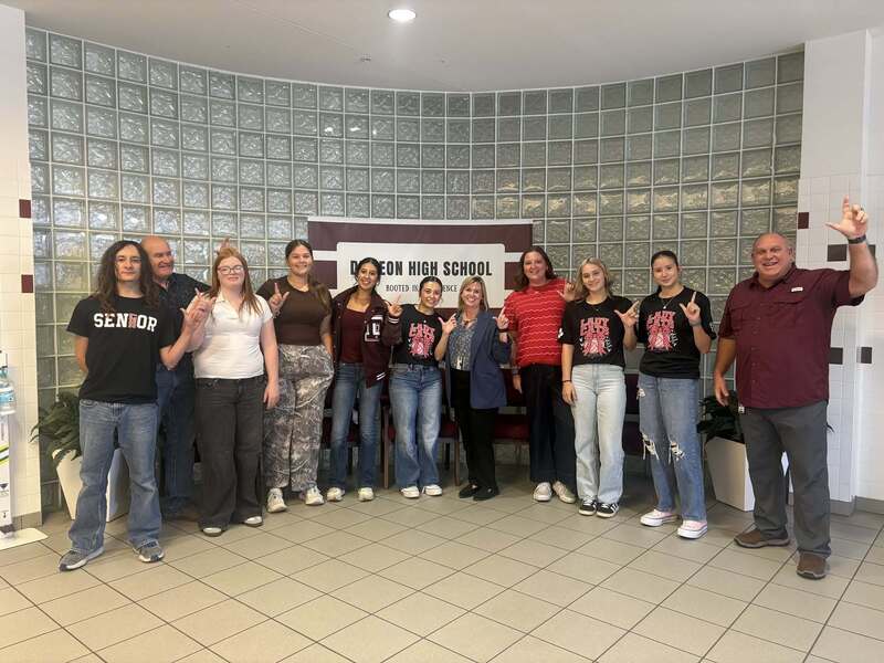 group picture of students, teachers and guest speaker in foyer