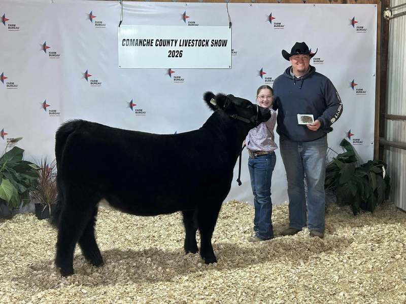 ffa member and parent standing next to her steer
