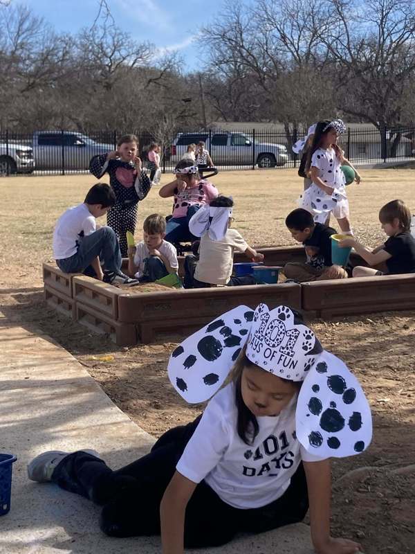 student dressed as dalmatians playing outside