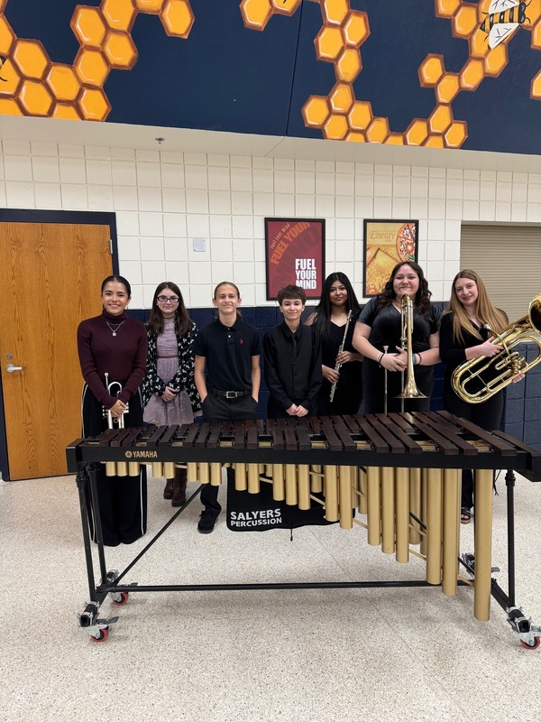 band members holding and standing with instruments 