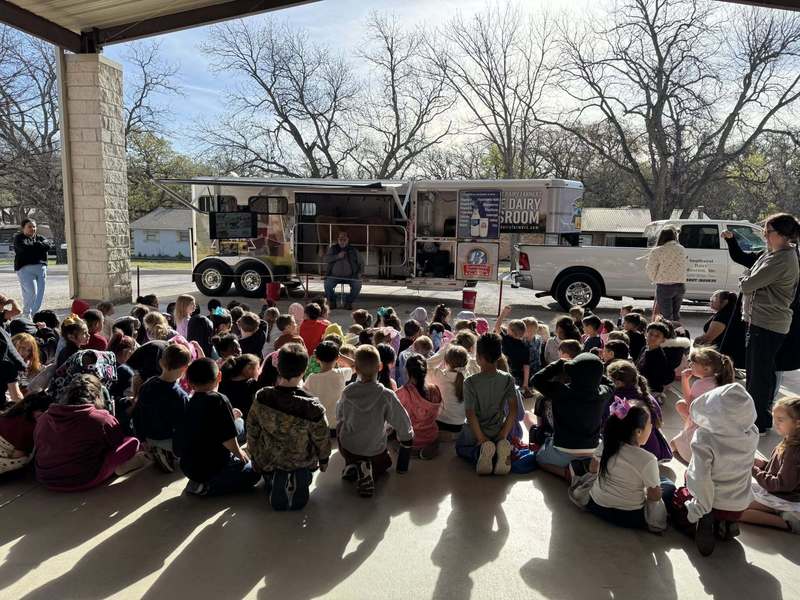 picture from behind group of students listening to guest speaker