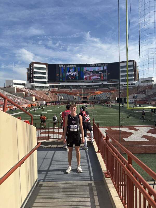 max jones standing on walkway at football stadium