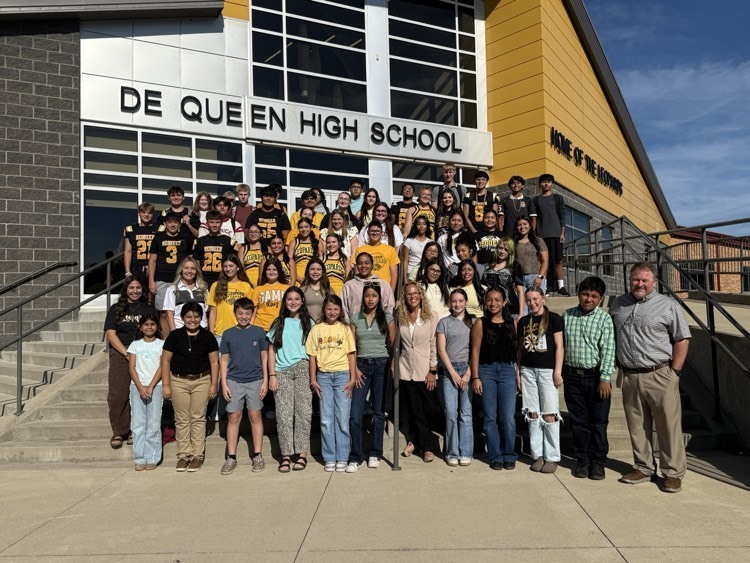 students with rep Vaught in front of school 