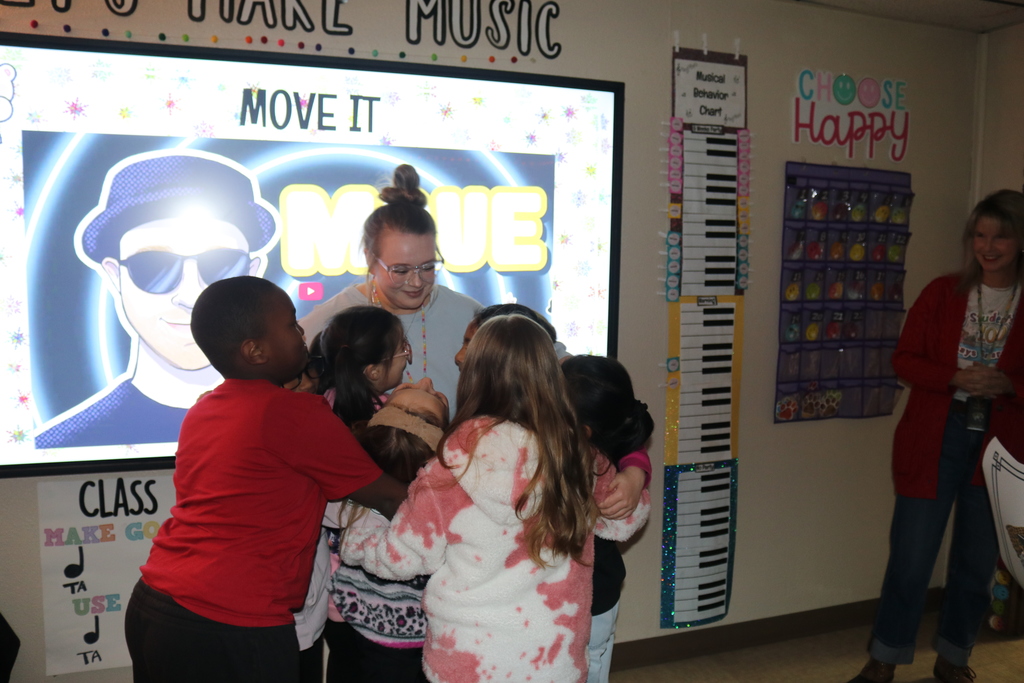 Class hugging Mrs. Smith