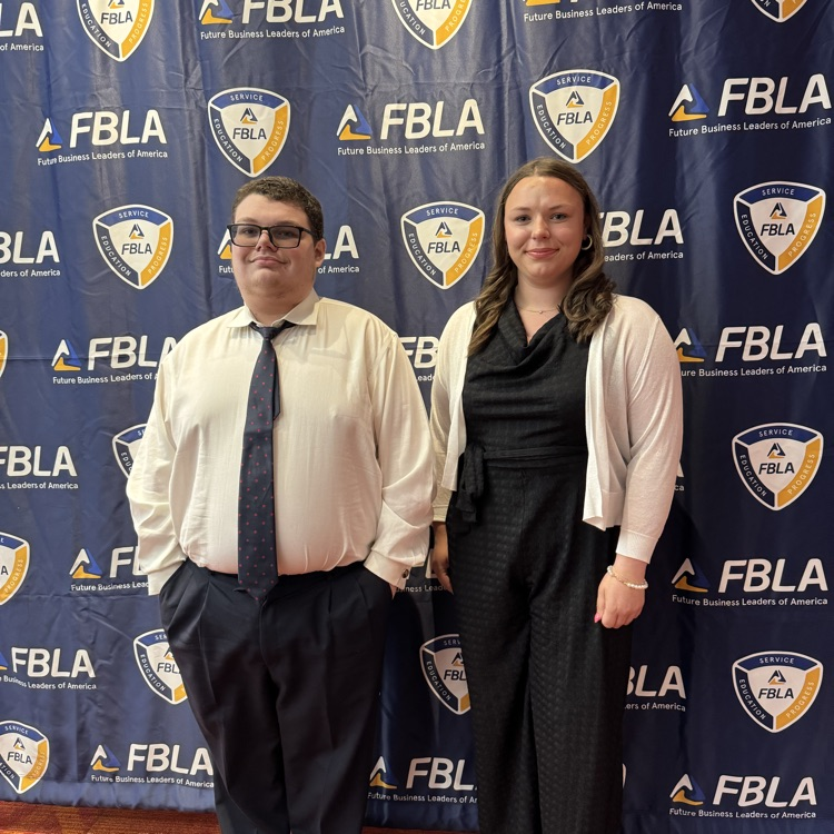 Efrain and Virginia holding FBLA awards