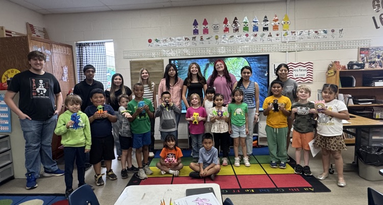 group picture of kindergarten students holding their monsters