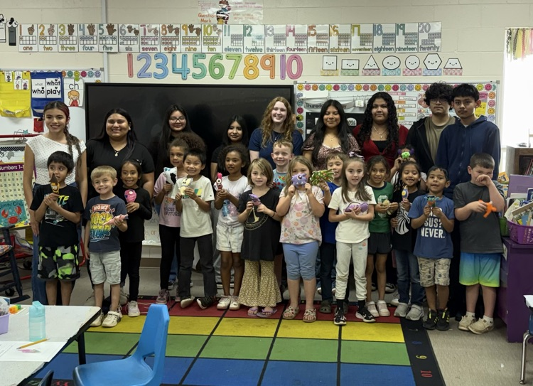 group picture of kindergarten students holding their monsters