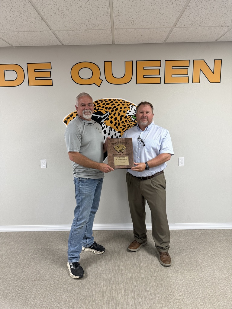 Kenny Martin Pictured with Superintendent Jason Sanders holding a plaque