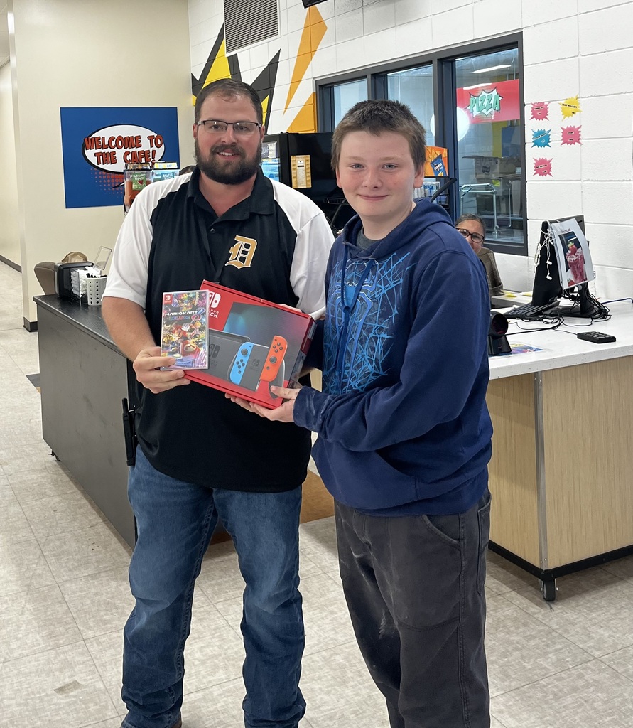 Mr. Hanney presenting Levi with his prize.