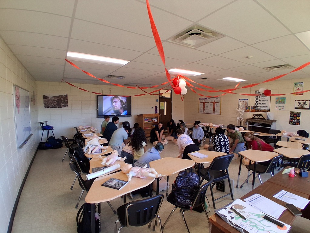 Students learning and practicing CPR