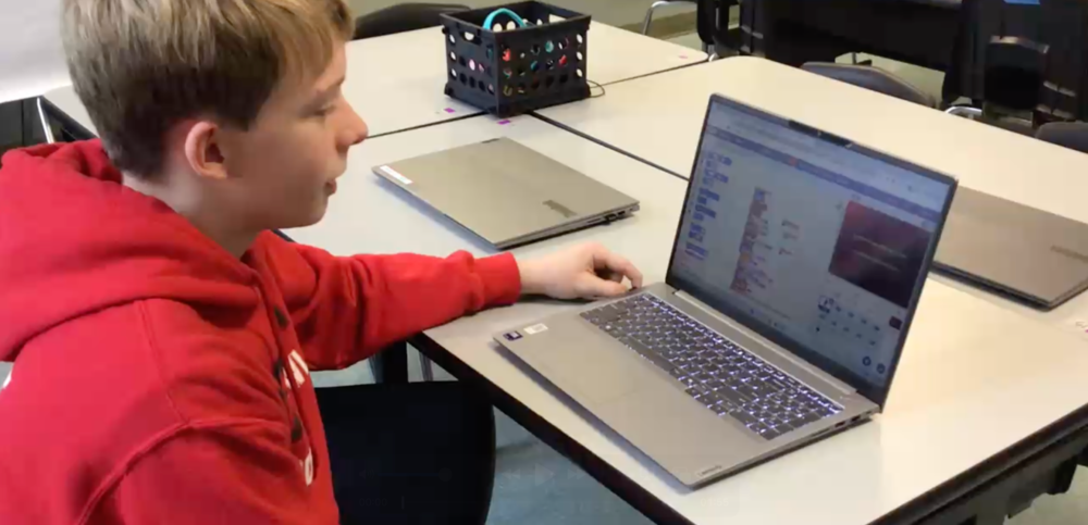 Image of CyberSecurity Student Landen Williams sitting at his computer