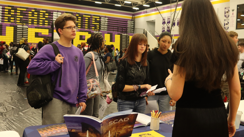 Students speak with a college representative during Bainbridge High School’s College and Military Fair.
