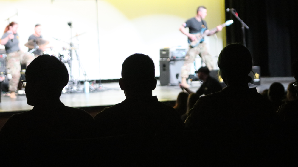 Students watch a live rock performance by the U.S. Army Field Band’s “As You Were” inside the Performing Arts Center.