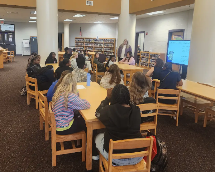 Bainbridge High School Early Childhood Education students participate in ABii robot training in the media center as they prepare to support reading and math instruction at three Decatur County schools.
