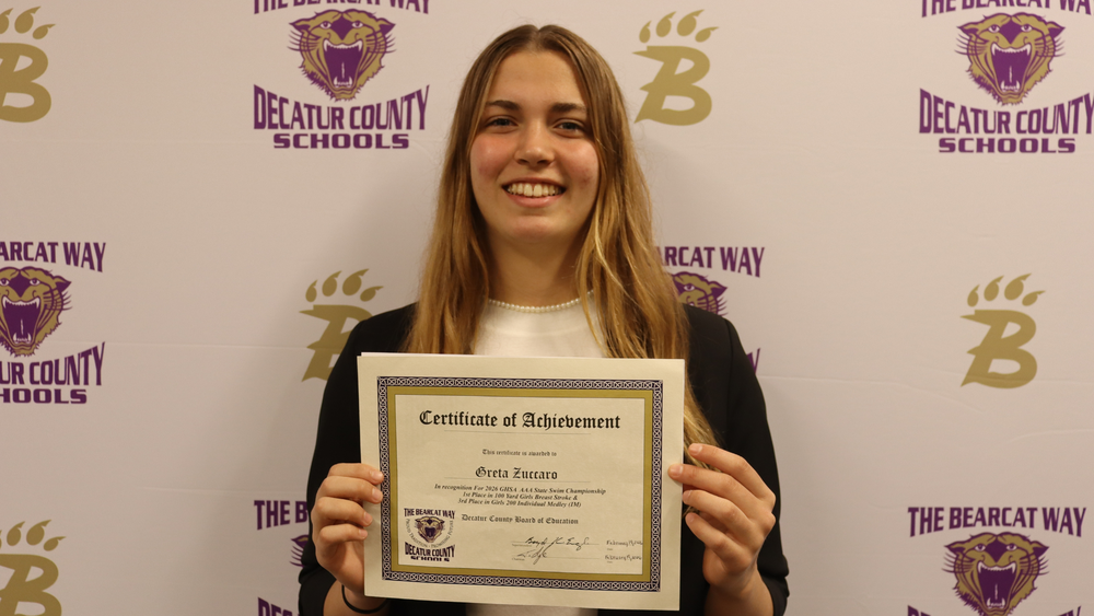 Student recognized by the Decatur County Schools Board of Education for athletic achievement during a board meeting