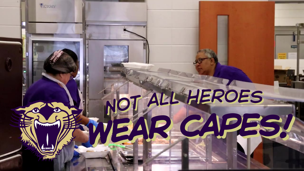 School cafeteria staff in purple uniforms serving food behind a lunch line, with text overlay reading “Not All Heroes Wear Capes!” and a gold bearcat logo.