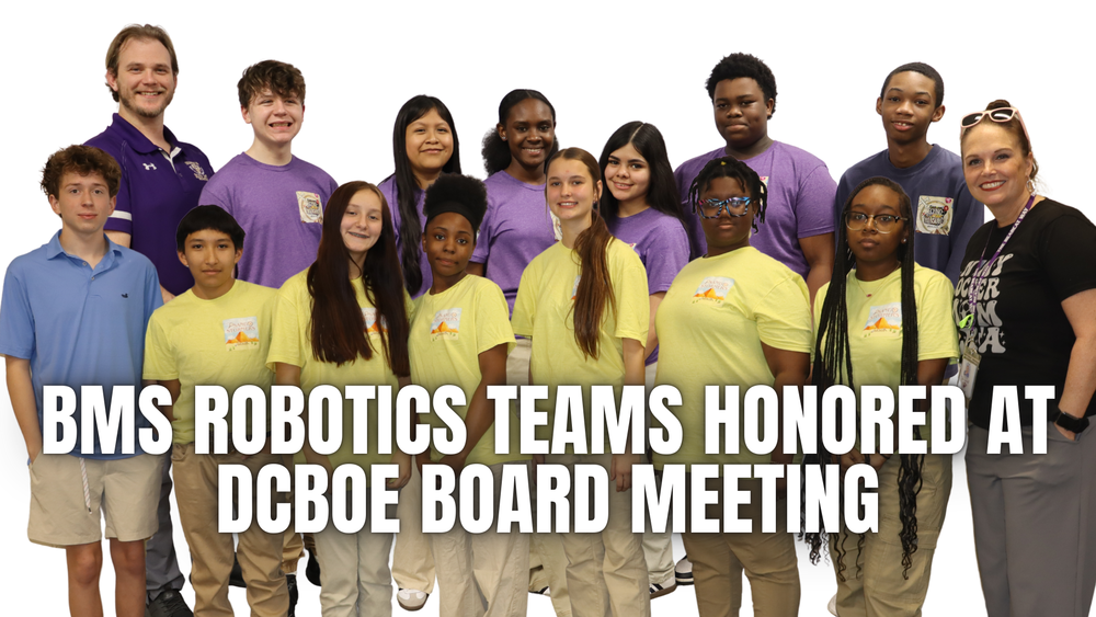 Group of middle school robotics students and coaches posing together as the text ‘BMS Robotics Teams Honored at DCBOE Board Meeting’ appears across the image.