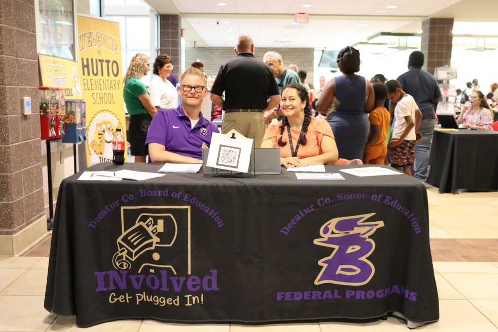 Decatur County Federal Programs staff greet families at an informational booth.