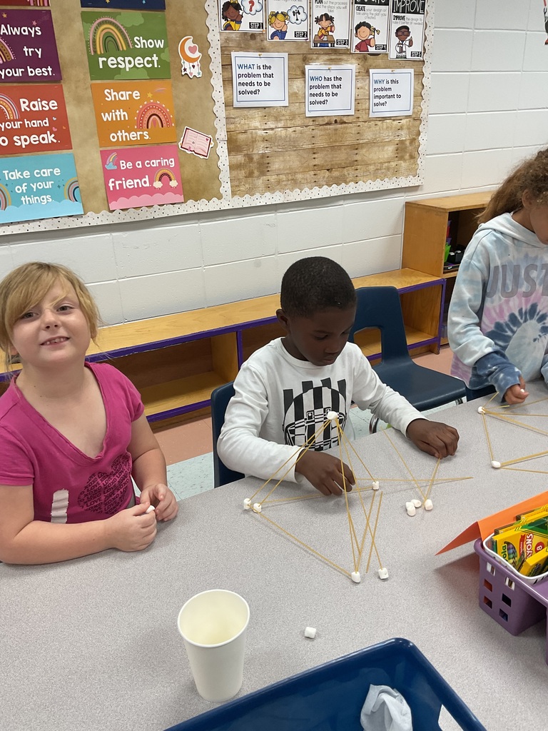 students build spaghetti and marshmallow structures during a classroom STEM activity.