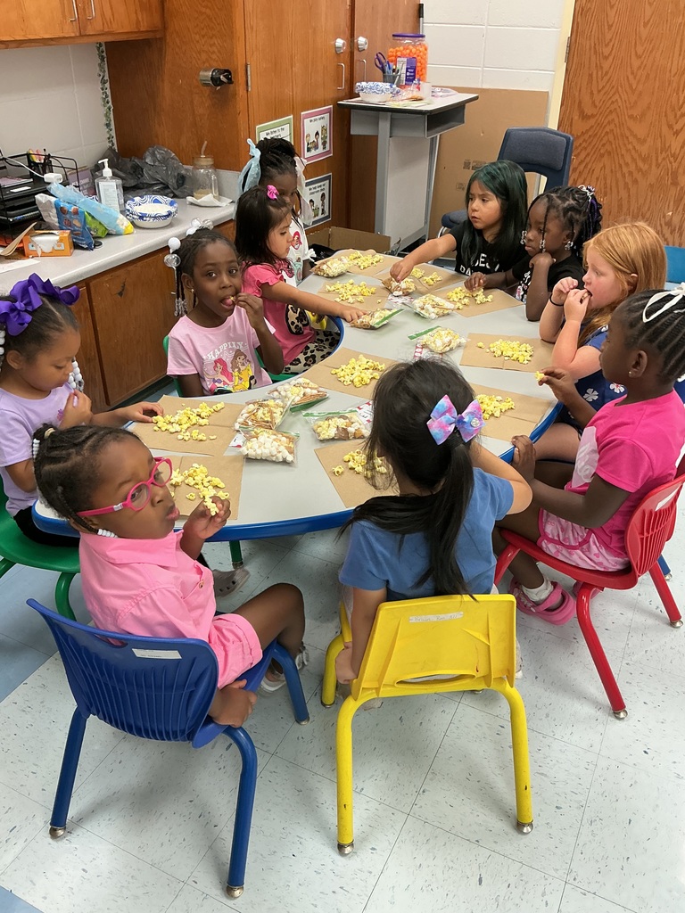 Students at table making trail mix.